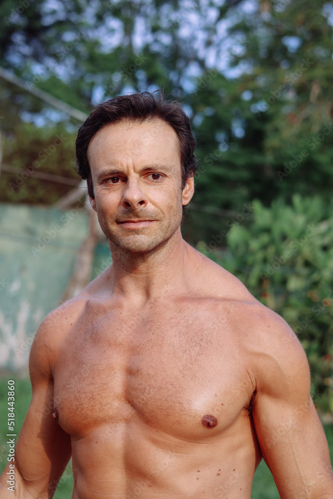 Portrait of a strong handsome man in the garden Portrait of a strong handsome man in the garden