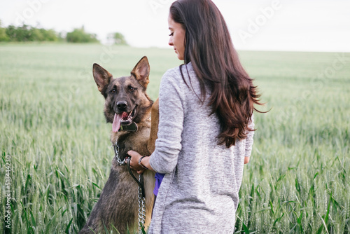 German shepherd dog and woman in coutryside photo