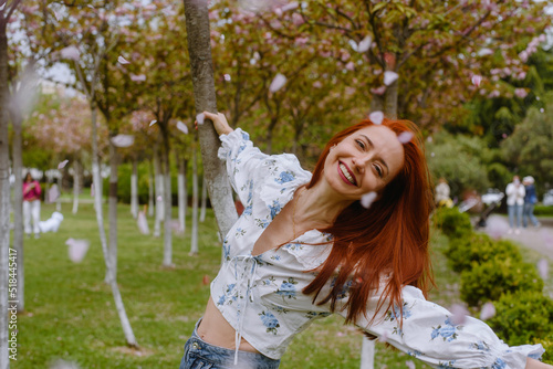 Happy woman in sakura blossom