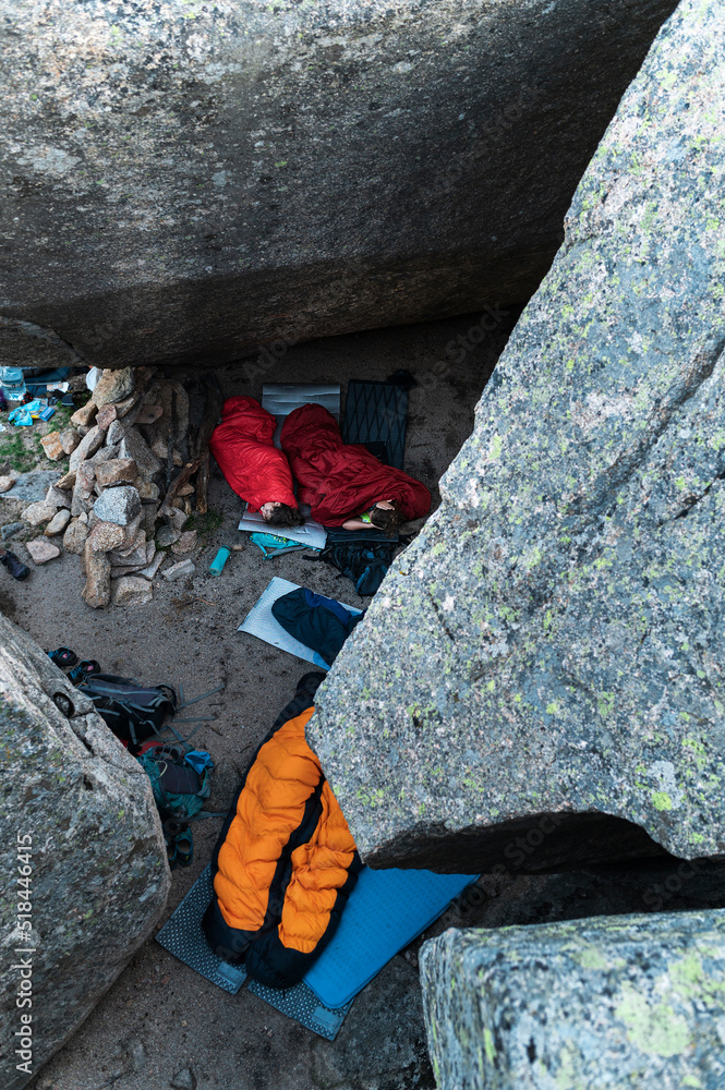 Sisters together wild camping into sleeping bag Sisters together wild camping into sleeping bag
