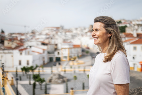 tourist mature woman looking from the top a village of white houses