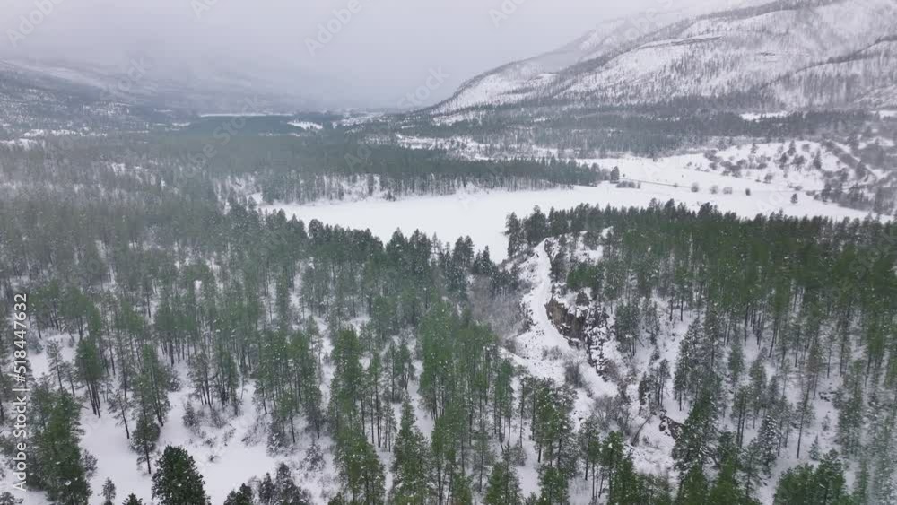Winter adventure vacation in cinematic Colorado canyons Aerial 4k shot. Beautiful winter mountain landscape. Drone moving above snow capped pine forest at moody weather. Cold winter concept. Winter adventure vacation in cinematic Colorado canyons Aerial 4k shot. Beautiful winter mountain landscape. Drone moving above snow capped pine forest at moody weather. Cold winter concept.