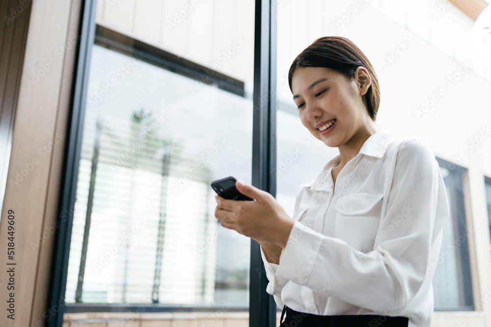 Asian businesswoman in formal suit in office happy and cheerful during using smartphone and working. Asian businesswoman in formal suit in office happy and cheerful during using smartphone and working.