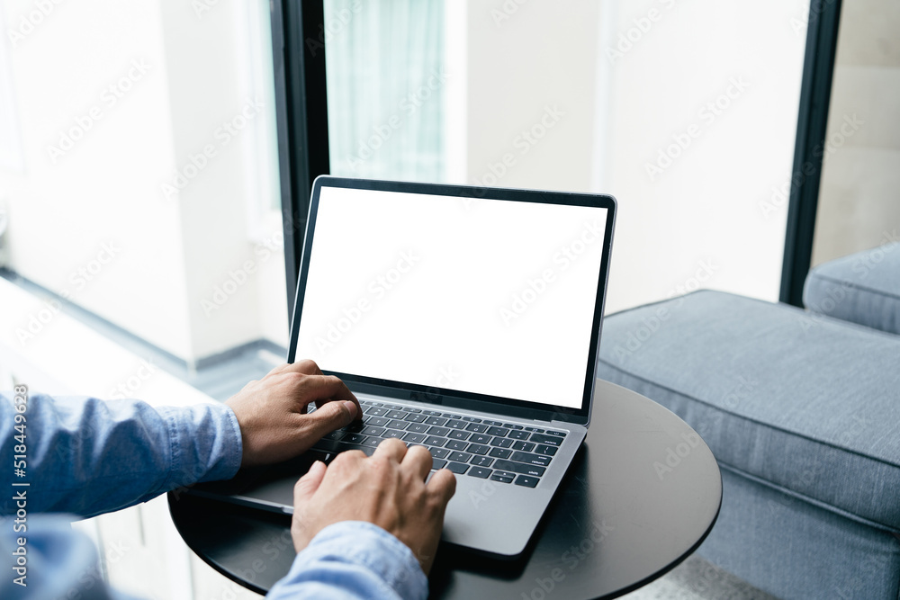 Close up view of man hands typing on keyboard of laptop computer on white desk at his home office. mockup laptop blank screen, clipping path. Close up view of man hands typing on keyboard of laptop computer on white desk at his home office. mockup laptop blank screen, clipping path.