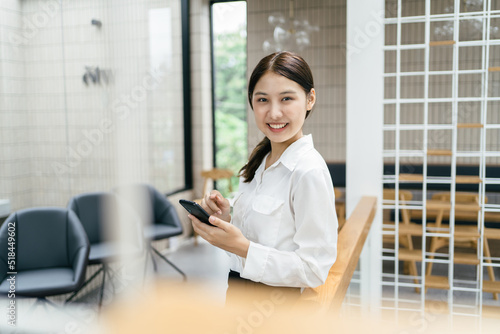Asian businesswoman in formal suit in office happy and cheerful during using smartphone and working. Free Download Asian businesswoman in formal suit in office happy and cheerful during using smartphone and working. - GFXLoad
