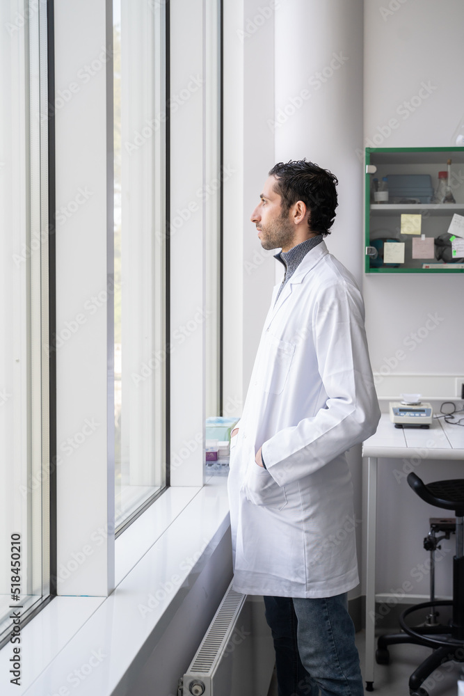 Researcher Looking Through The Lab Window Researcher Looking Through The Lab Window