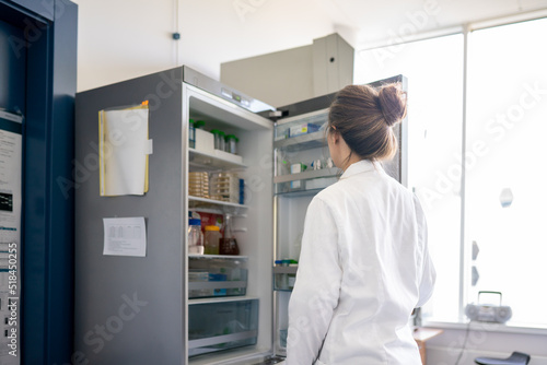 Wallpaper Mural Woman Looking At Open Refrigerator In The Lab Torontodigital.ca