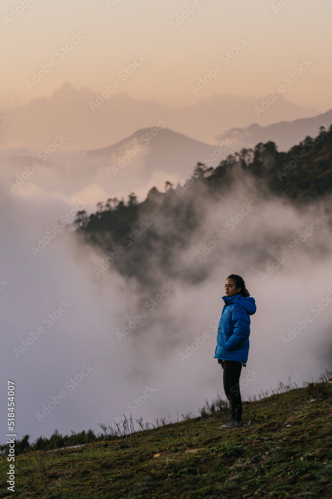 Woman enjoying view from top of a mountain Woman enjoying view from top of a mountain