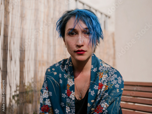 Close up portrait of a young women with blue short hair photo