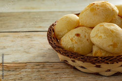 close up cheese bread, or brazilian pão de queijo. coffee beans on the background over wooden table photo