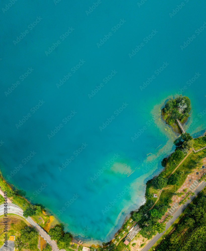Aerial drone view of lake scenery with turquoise water in Tasik Puteri, Bukit Besi, Terengganu, Malaysia.