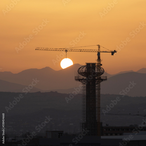 Crane lowering the Sun  photo