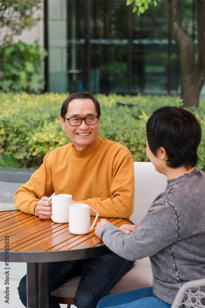 mature couple enjoying coffee outdoors and looking at each other mature couple enjoying coffee outdoors and looking at each other
