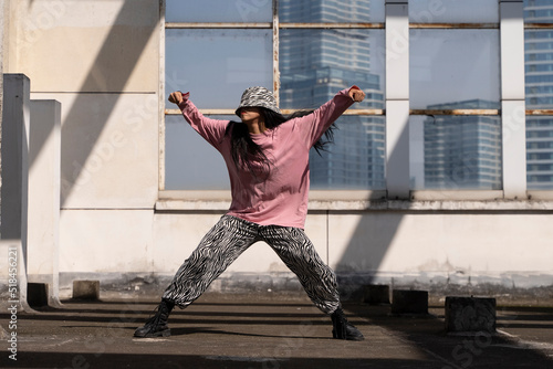 young woman hip hop dance on the roof photo