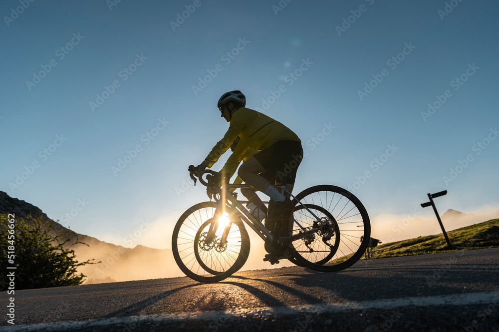 Sporty couple cycling on misty morning Sporty couple cycling on misty morning