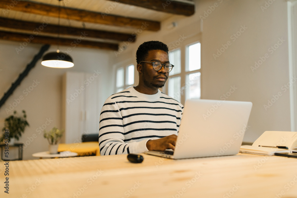 Millennial freelancer working online via computer Millennial freelancer working online via computer