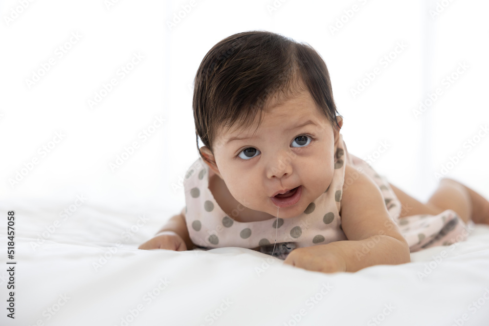 cute baby crawling on bed and drooling from mouth cute baby crawling on bed and drooling from mouth