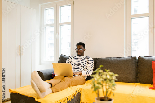 Young male entertaining with laptop Indoor