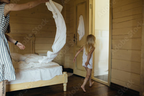 The little girl runs to bathe in the bathroom. photo