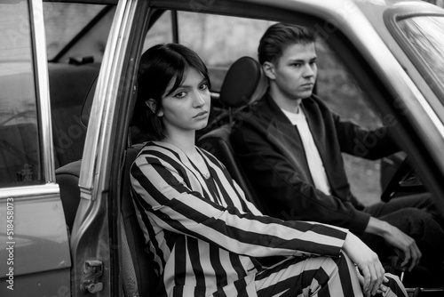 A stylish couple inside a car