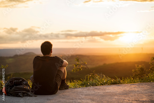 Man looking at a sunset. photo