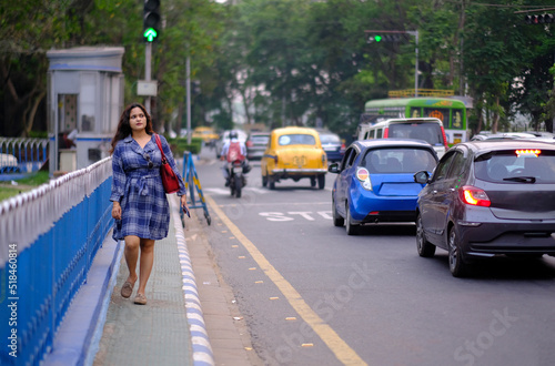 Young pretty woman walking through a busy street in urban area