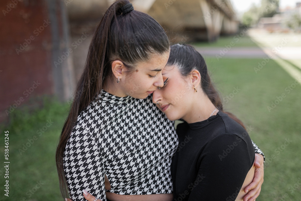 young lesbian couple together in a city park