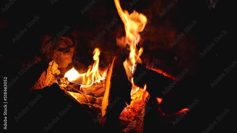 Red fire in a campfire made of stones. A campfire at night. Red embers, black wood and gray ashes. Close-up Red fire in a campfire made of stones. A campfire at night. Red embers, black wood and gray ashes. Close-up