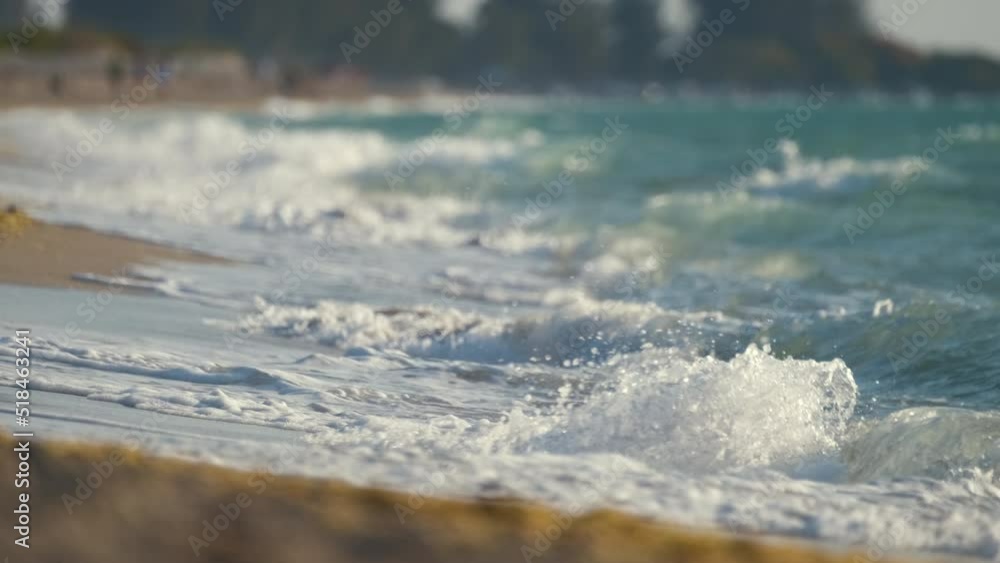 Seaside sand beach with foamy waves crushing on shore Seaside sand beach with foamy waves crushing on shore