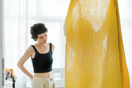 Two women in a tailor's workshop select correct fabric  photo