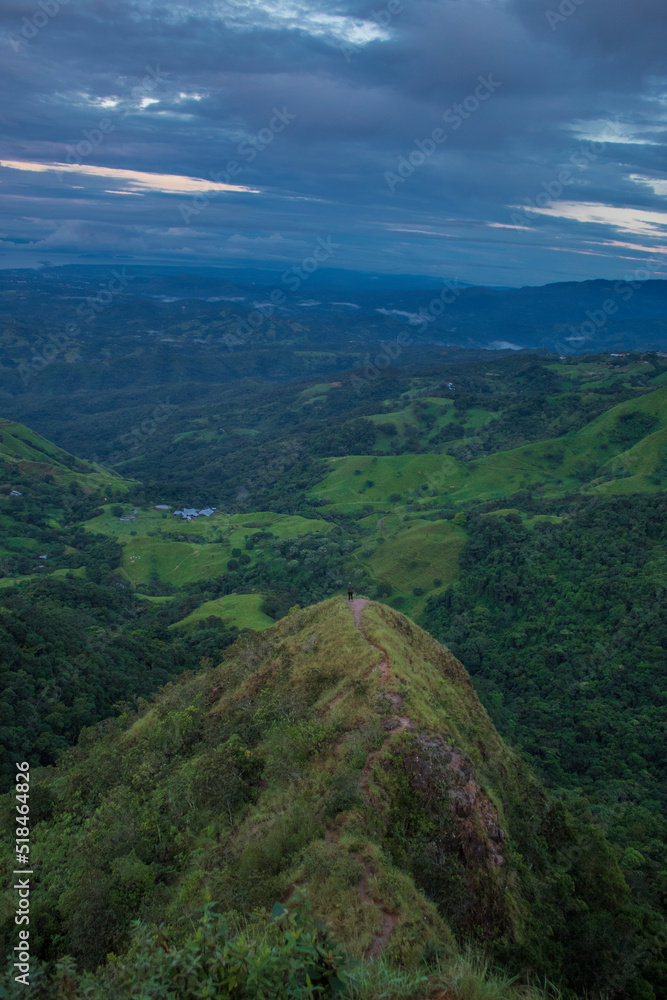view towards a top of a hill in the middle of the green mountains of Costa Rica