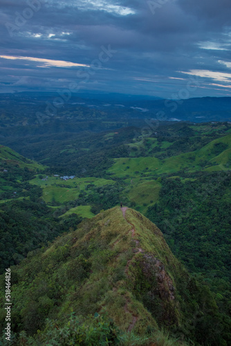 view towards a top of a hill in the middle of the green mountains of Costa Rica