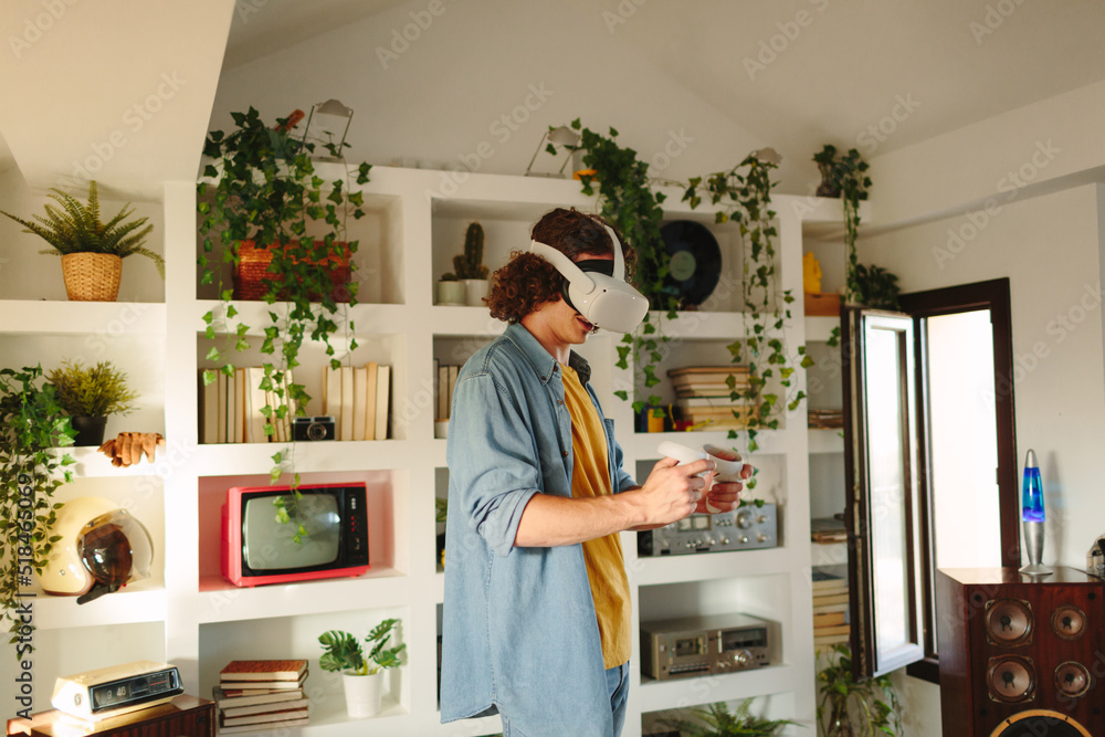 Boy looking his hand while using virtual reality head Boy looking his hand while using virtual reality head