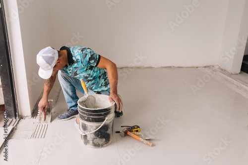 Ceramic tile installer working in one room photo