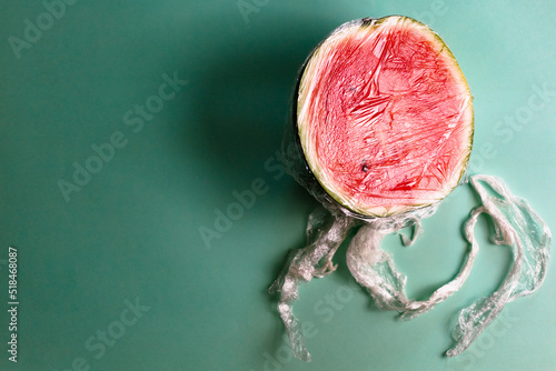 A watermelon covered by plastic photo