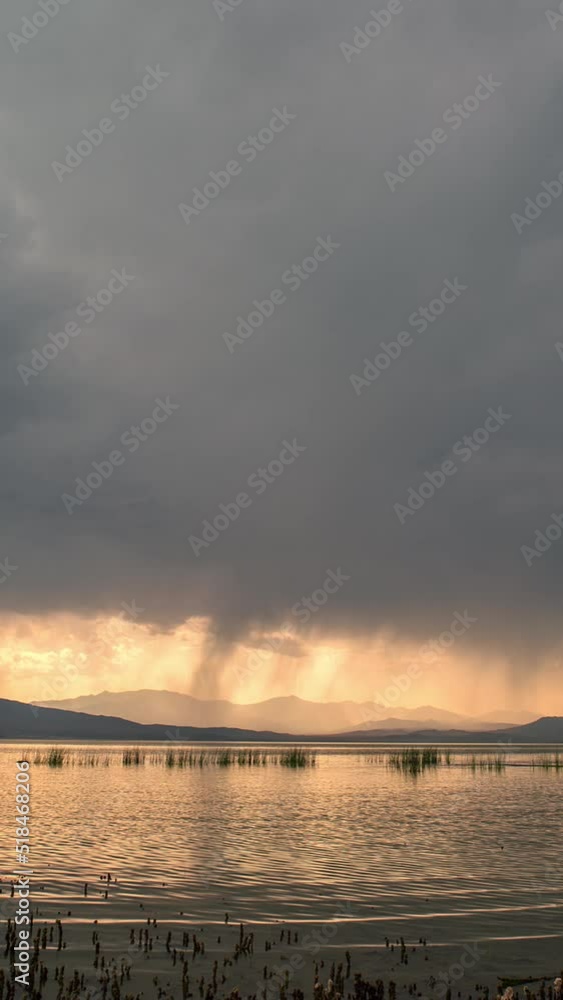 Summer storm moving in over Utah Lake in time-lapse on summer evening. Summer storm moving in over Utah Lake in time-lapse on summer evening.