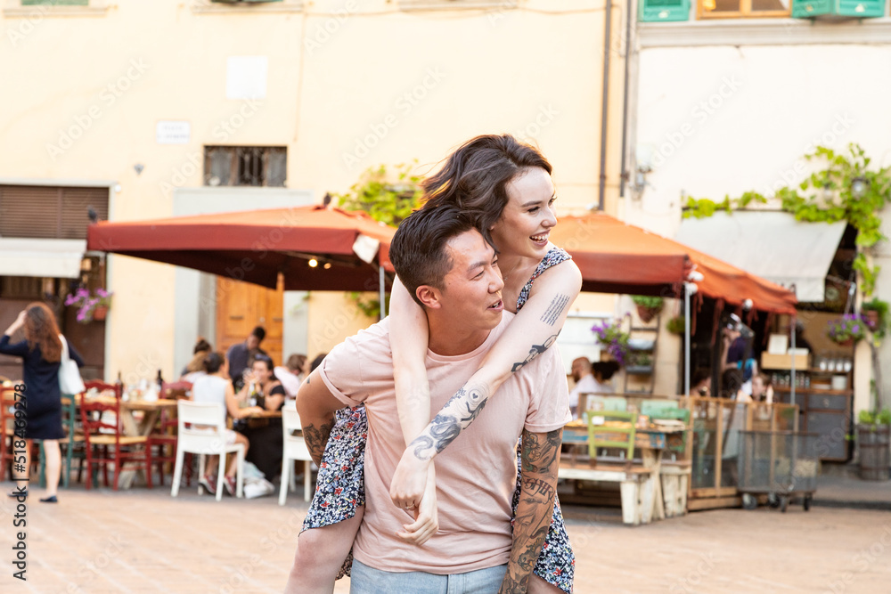 Stylish couple playing together in Italian courtyard Stylish couple playing together in Italian courtyard