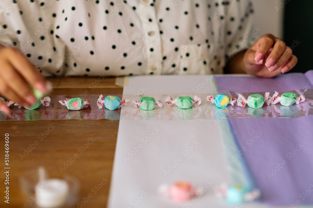 Female making taffy graduation candy lei Female making taffy graduation candy lei
