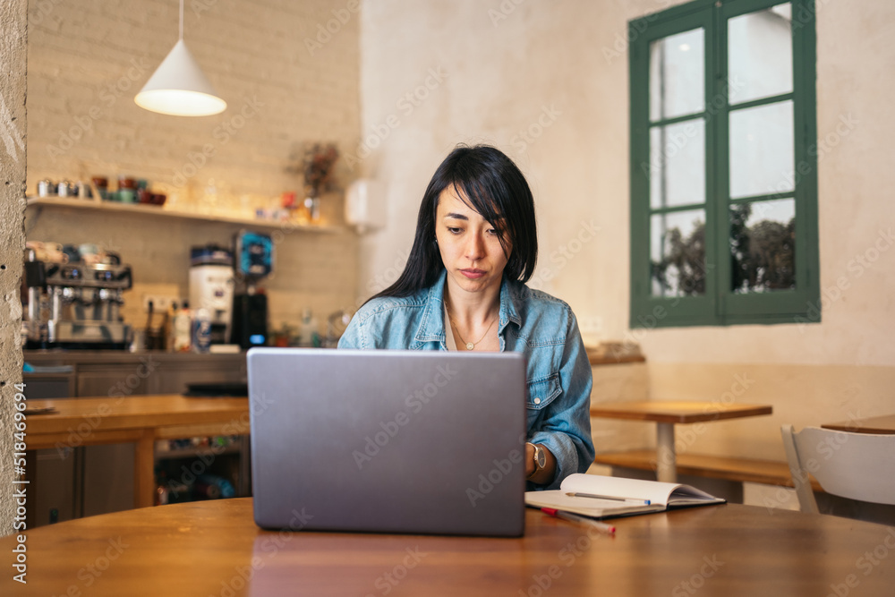 Freelance woman Working Alone In Coffee House Freelance woman Working Alone In Coffee House