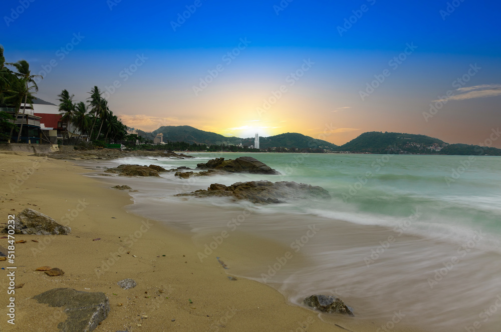 Colourful Skies Sunset over Patong Beach in Phuket island Thailand. Lovely turquoise blue waters, lush green mountains colourful skies and beautiful views of Pa Tong