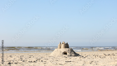 Pretty sand castle on a beach photo