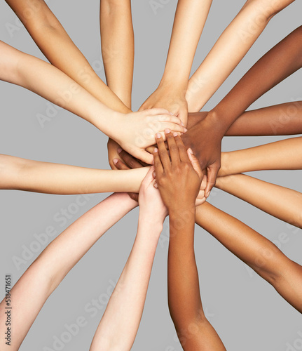 Group of diverse women's hands connected together in inclusion 