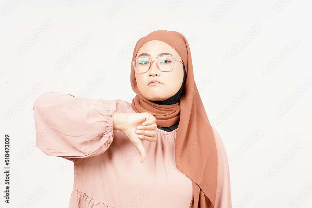Showing Thumbs Down of Beautiful Asian Woman Wearing Hijab Isolated On White Background Showing Thumbs Down of Beautiful Asian Woman Wearing Hijab Isolated On White Background