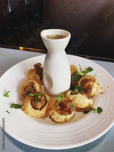 Pani puri on a plate at a restaurant photo