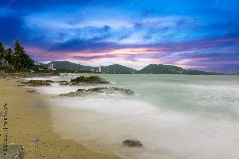 Colourful Skies Sunset over Patong Beach in Phuket island Thailand. Lovely turquoise blue waters, lush green mountains colourful skies and beautiful views of Pa Tong