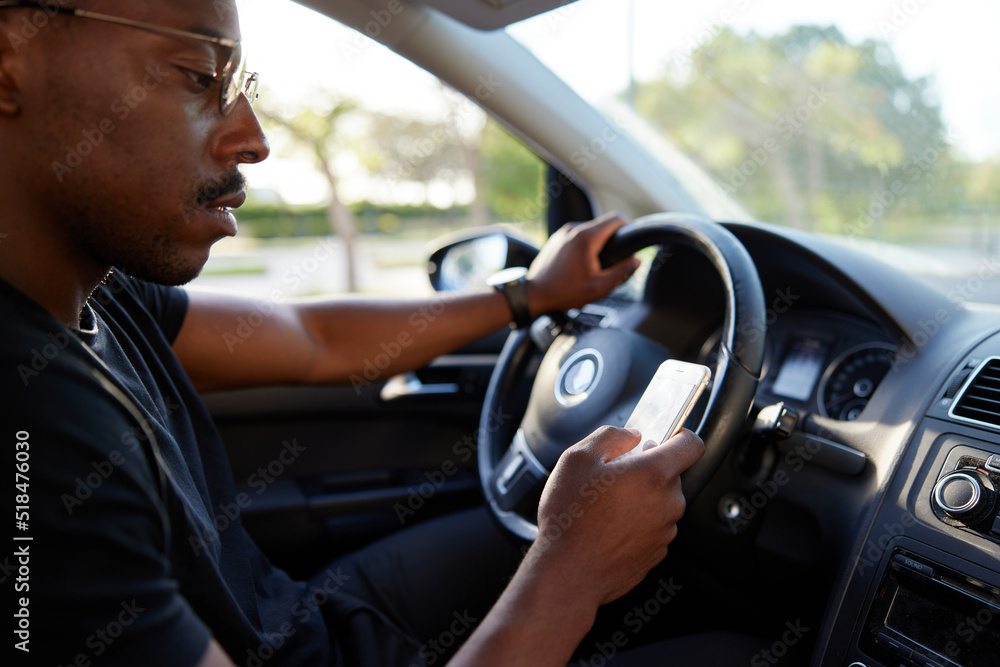 Crop black male driver using smartwatch during trip Crop black male driver using smartwatch during trip