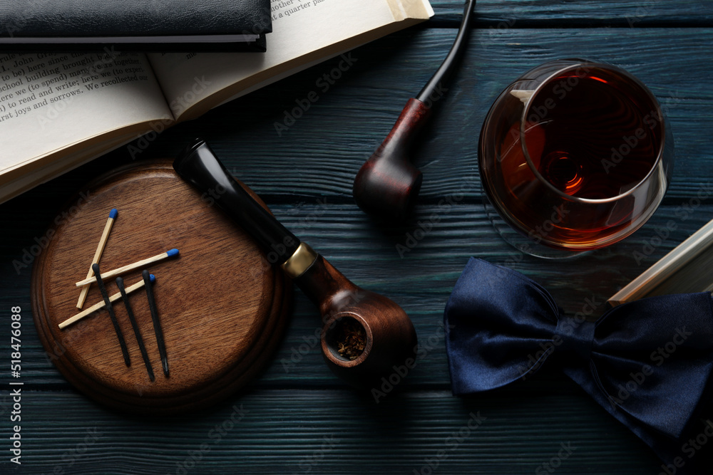 Composition of relaxation with smoking tobacco with smoking pipe, on wooden table