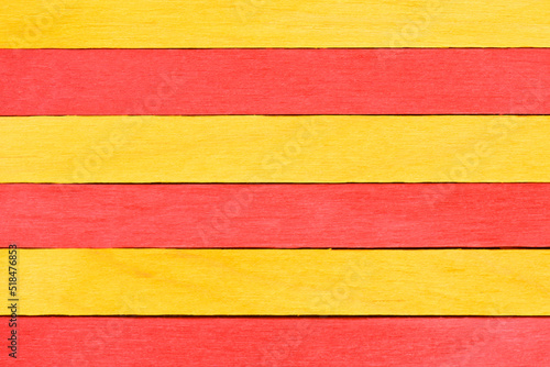 Vivid colorful red and yellow wood planks texture or background. Wooden textured background. Alternating red and yellow painted straight boards.