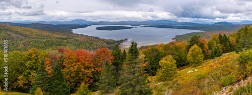 Height of Land - A panoramic overview of Mooselookmeguntic Lake and its surrounding rolling hills on a colorful but stormy Autumn day, as seen from Height of Land at side of Route 17, Maine, USA. photo