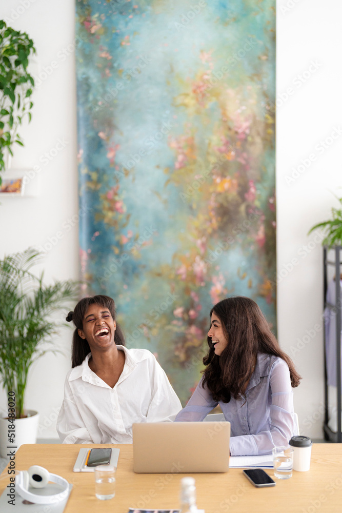 © Studio Marmellata/Stocksy - Diverse coworkers laughing at joke